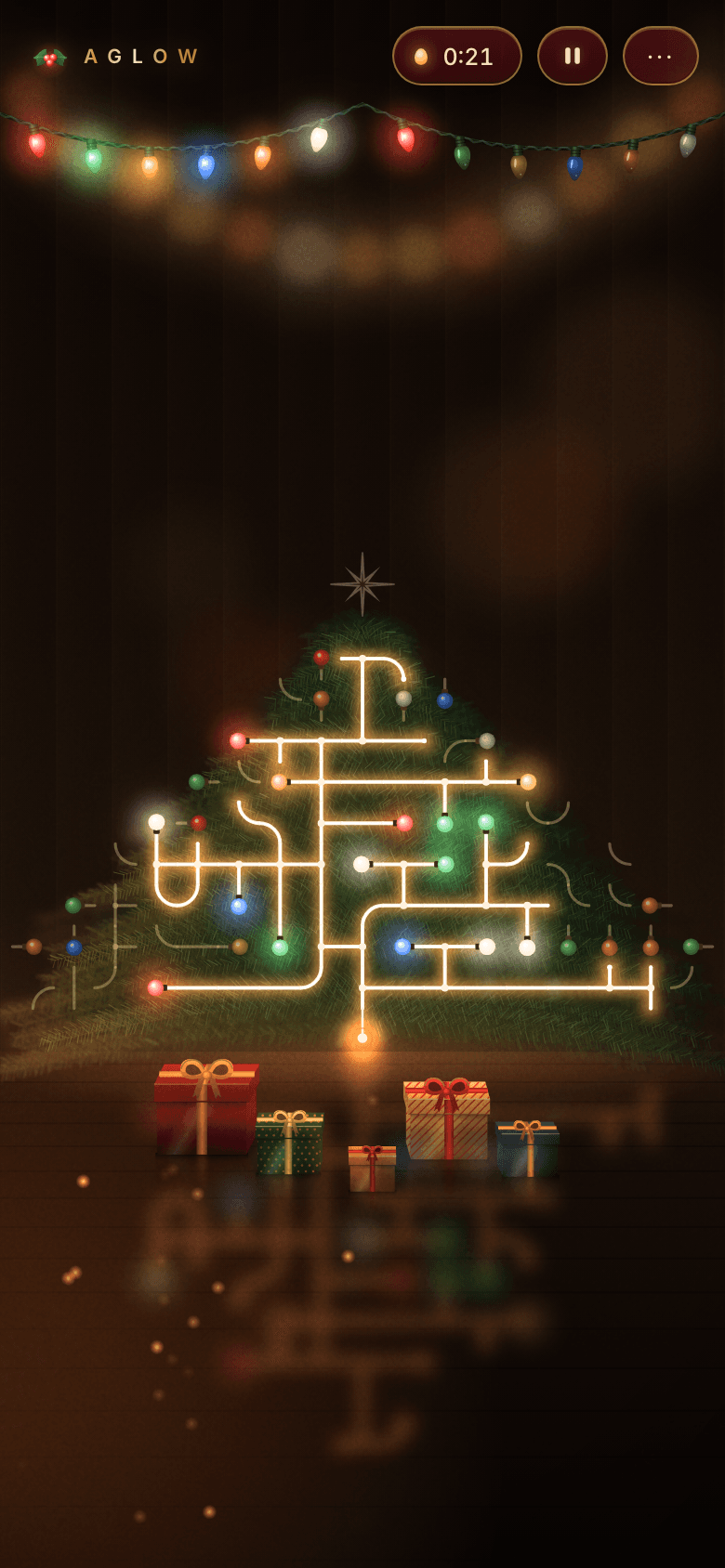 Aglow on a phone in portrait: the half-lit tree fits the screen width, the presents sit in front of it on the floor, and the lights reflect in the floorboards below